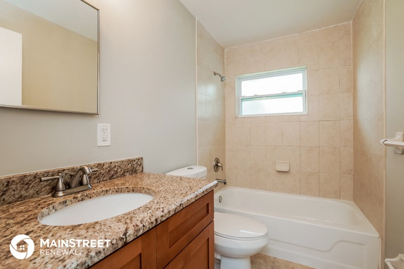 a bathroom with a sink and a toilet and a tub