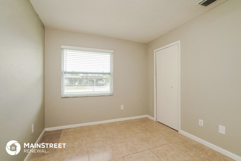 the interior of an empty room with beige walls and a window