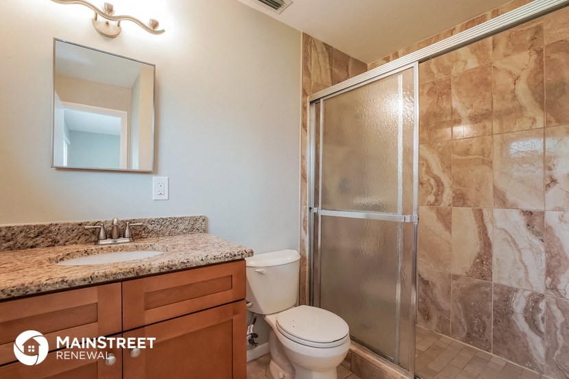 a bathroom with a toilet sink and a shower