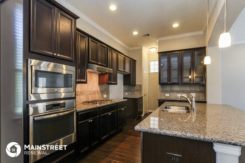 a kitchen with stainless steel appliances and granite counter tops