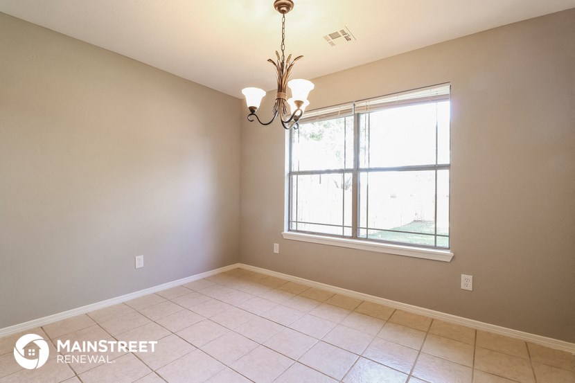 an empty dining room with a large window