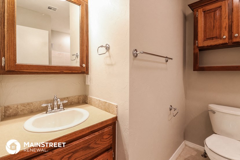a bathroom with a sink and a mirror and a toilet
