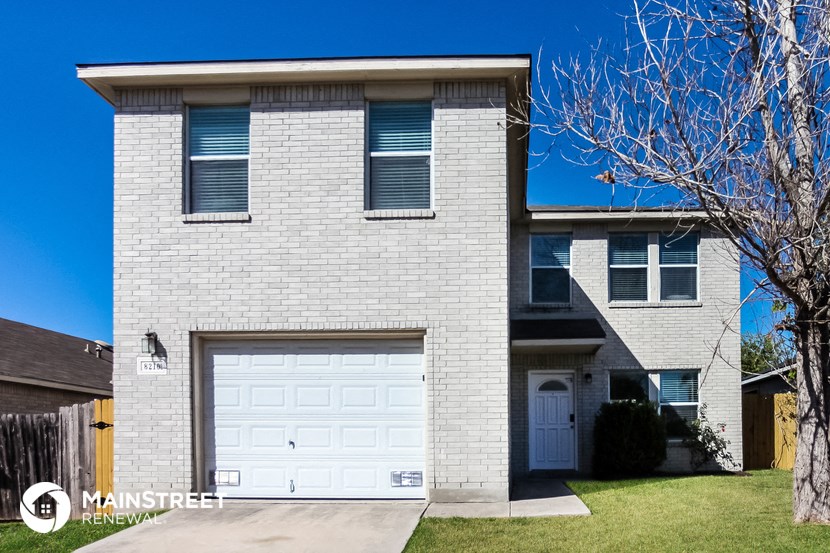 a white brick house with a white garage door