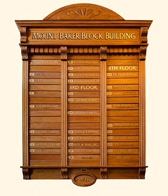 A sign for Mount Baker Block Building with three floors listed.