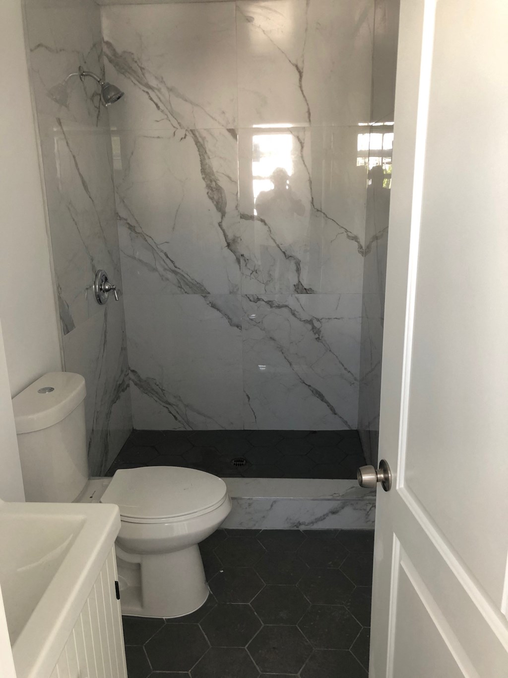 a small bathroom with a toilet and a shower