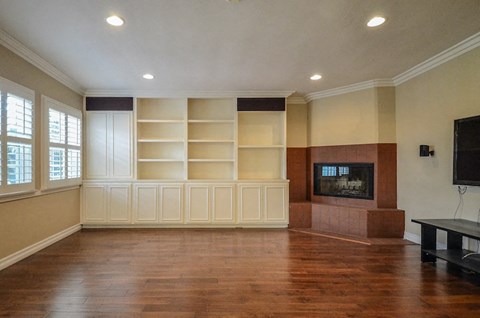 A living room with a fireplace and a television.