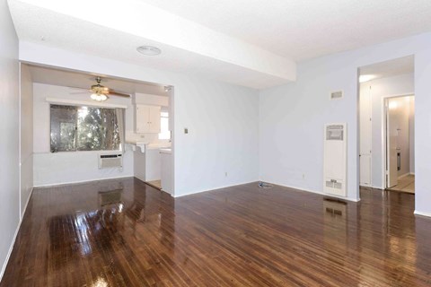 A room with wooden floors and white walls.