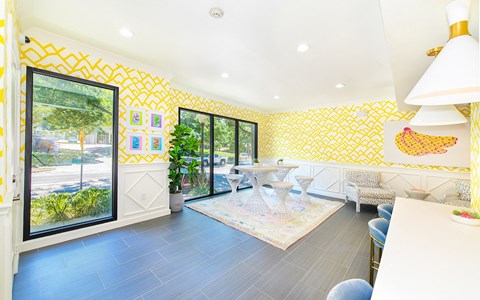 a dining room with yellow wallpaper and a table and chairs