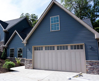 a blue house with a white garage door