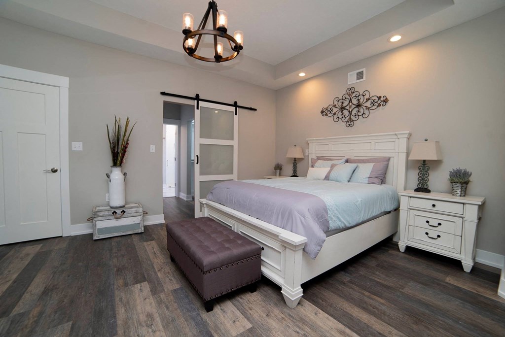 a bedroom with a bed and a door to a bathroom