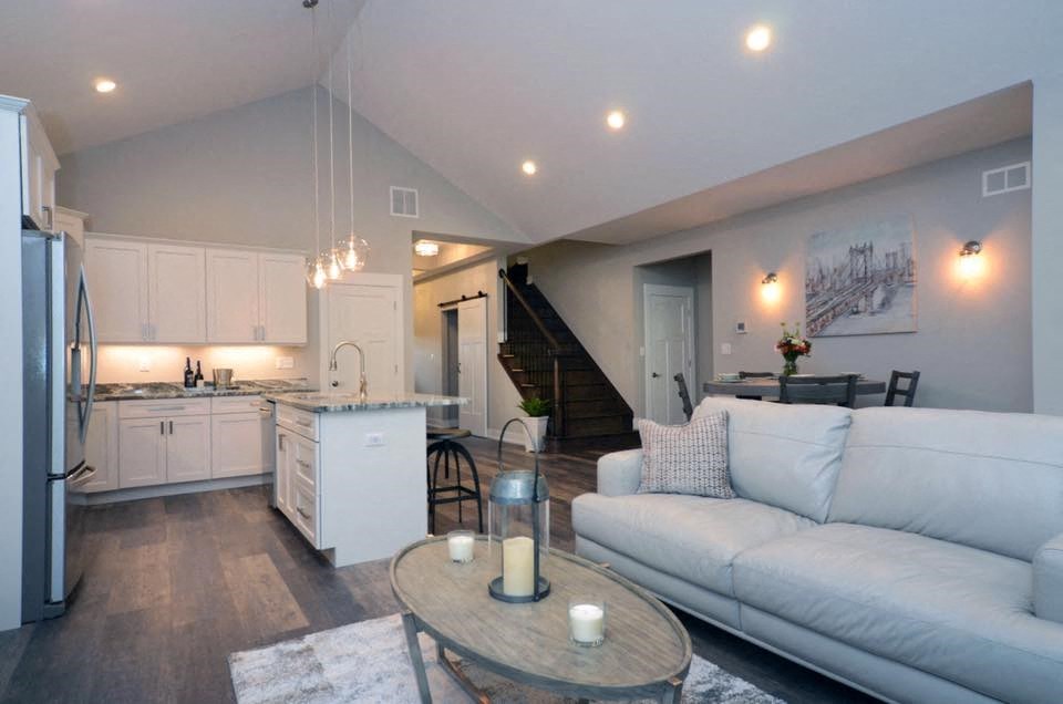 a living room and kitchen with a couch and a table