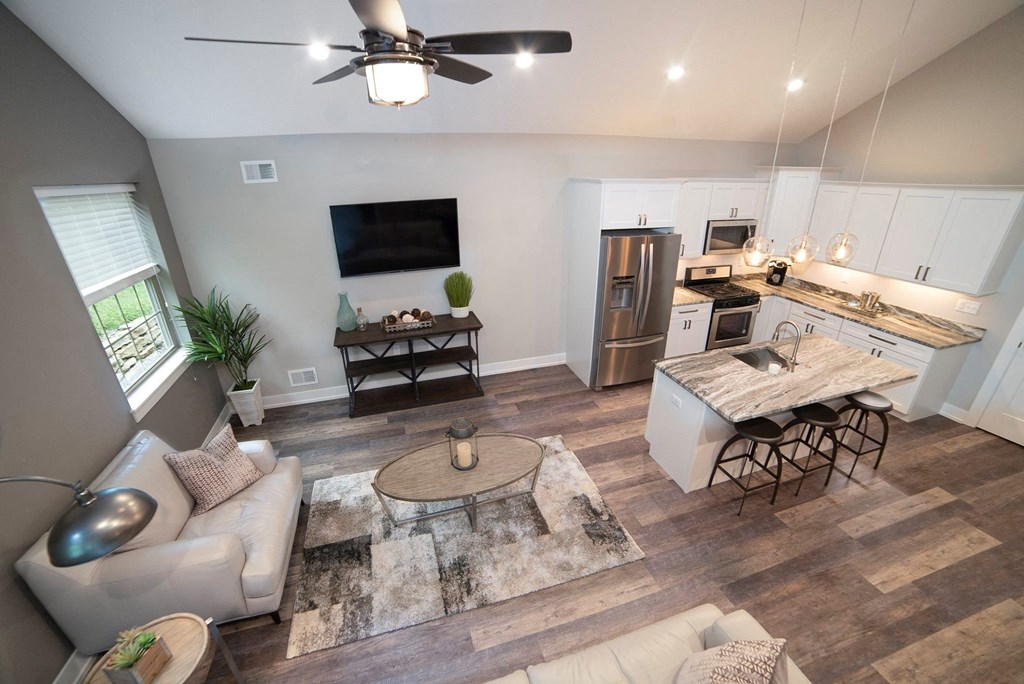 a living room and kitchen with a couch and a table