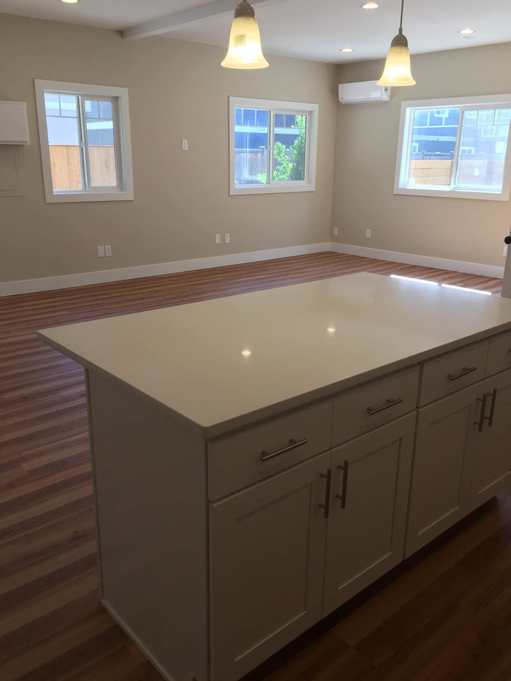 an empty kitchen with an island in the middle