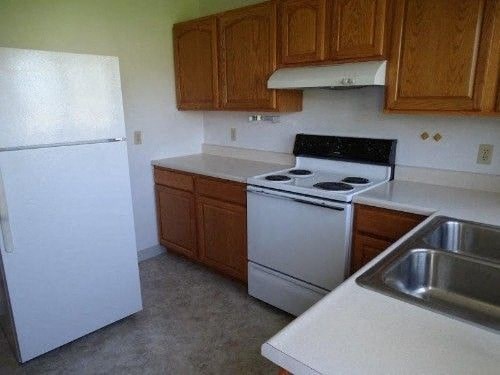 a kitchen with a stove and a refrigerator