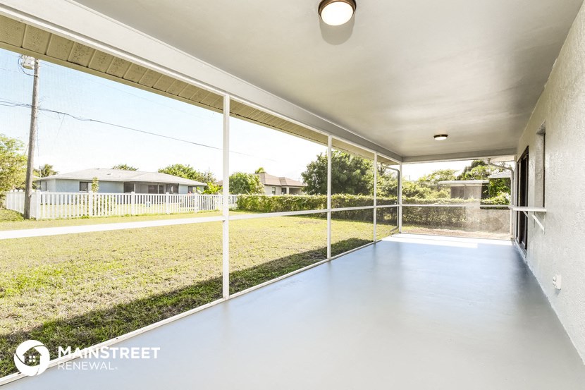 a patio with a yard and a glass sliding glass door