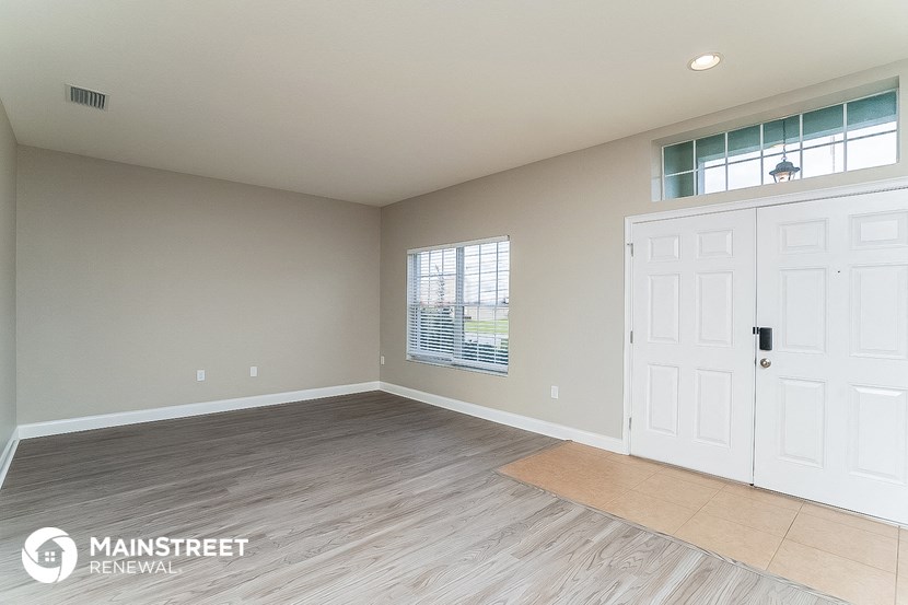 the living room of a new home with a white door