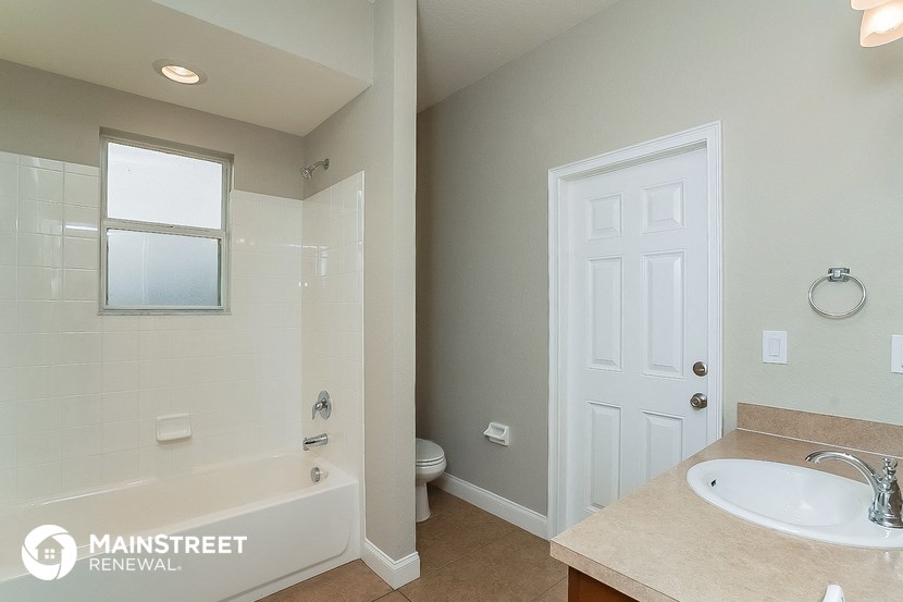 a bathroom with a tub and a sink and a toilet