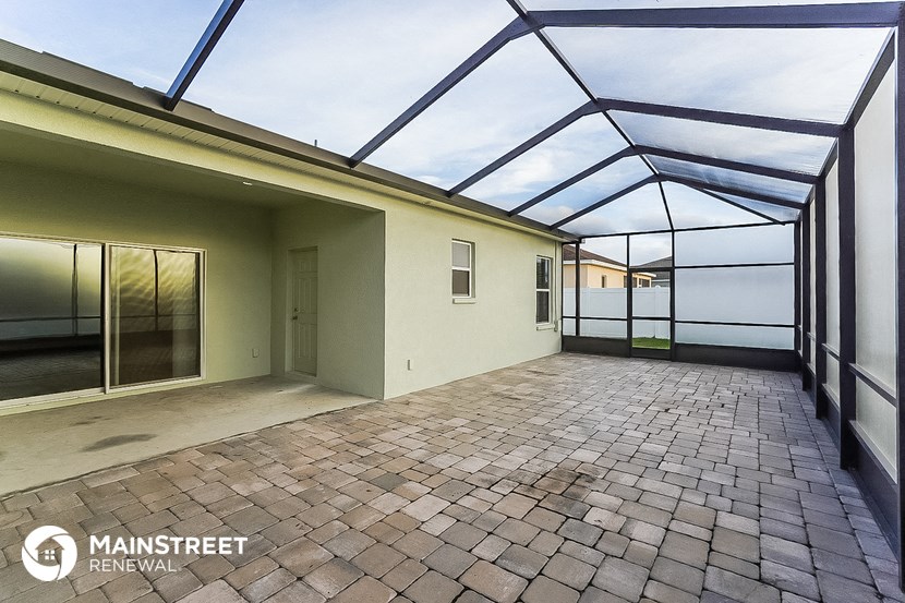 a glass roofed room with a brick floor and glass walls