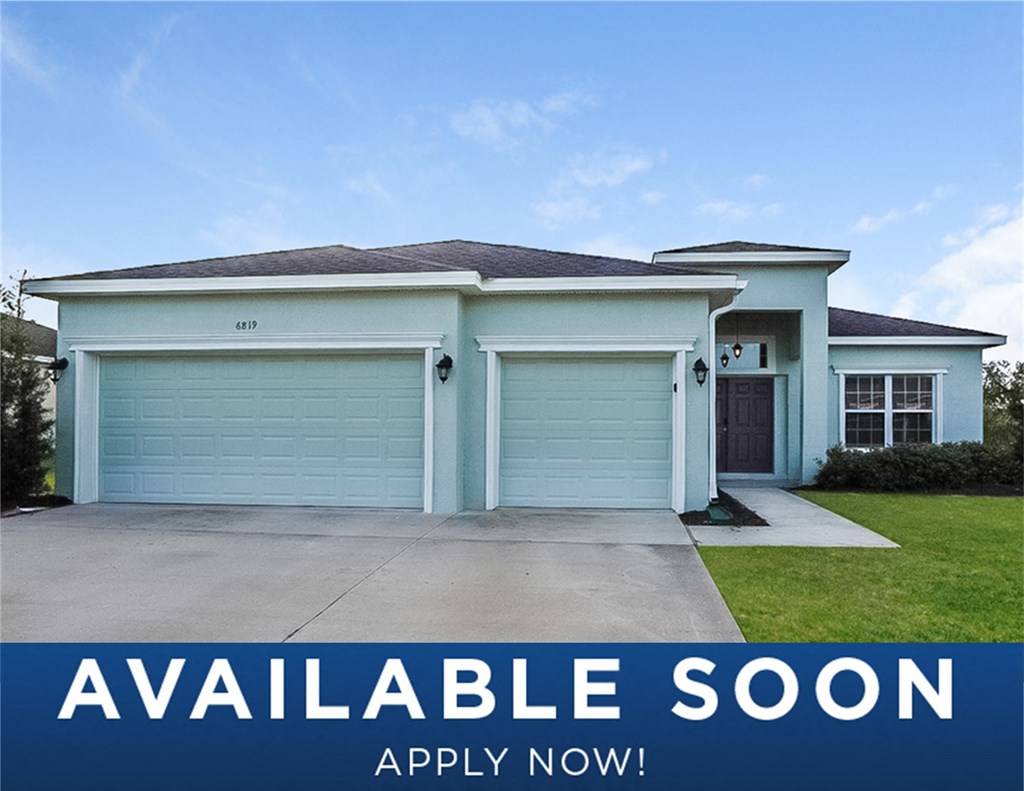 a white house with a garage and a driveway