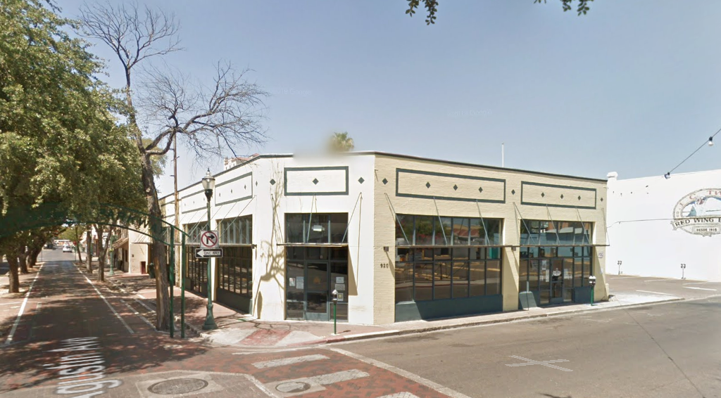 an old building on the corner of a city street