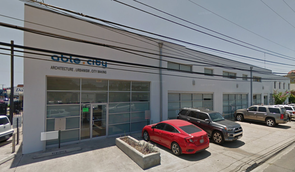 the front of a dealership with cars parked outside