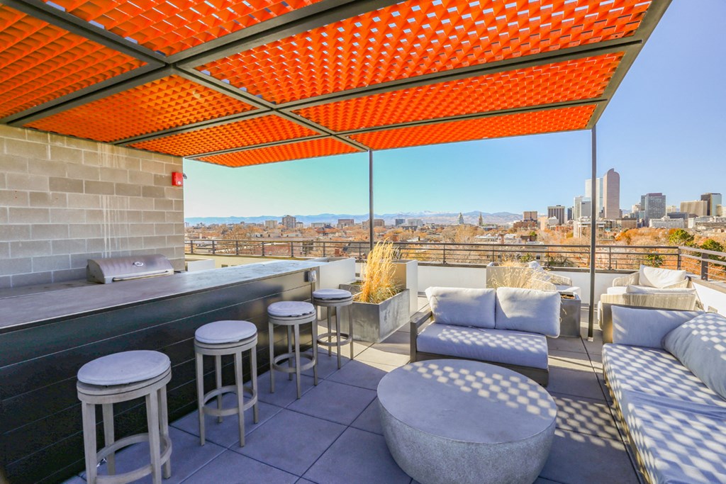 a rooftop bar with a view of the city