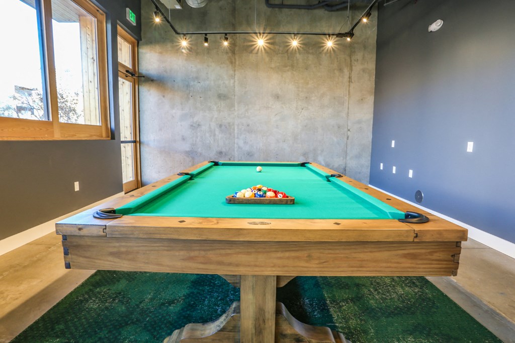 a pool table in a house with a green pool