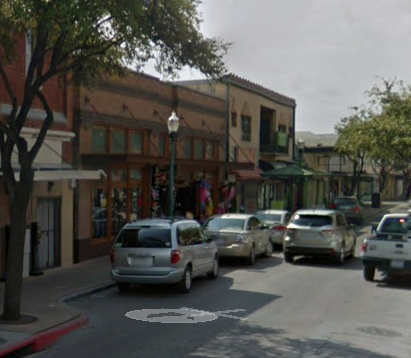 a busy city street with cars driving down it