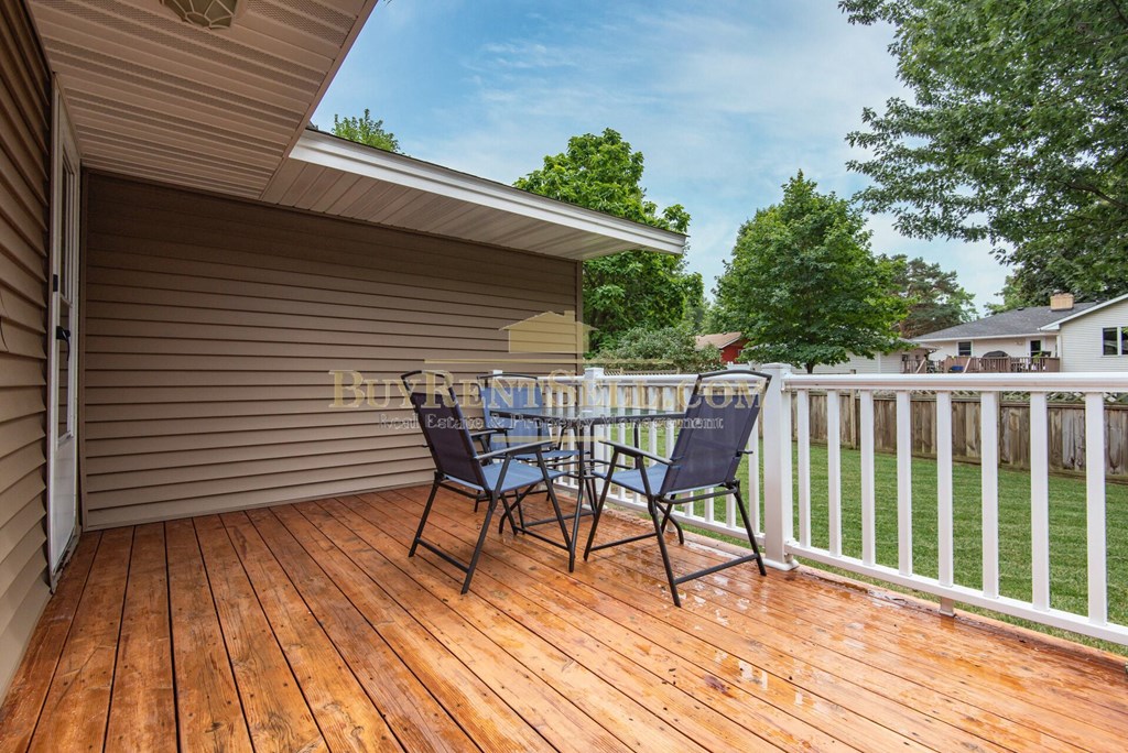 a deck with a table and chairs on it