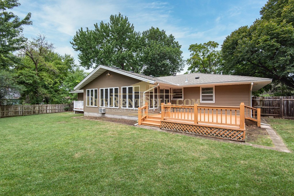 a house with a yard and a deck