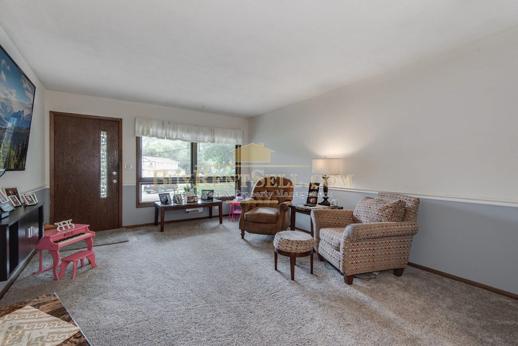 a living room with furniture and a large window