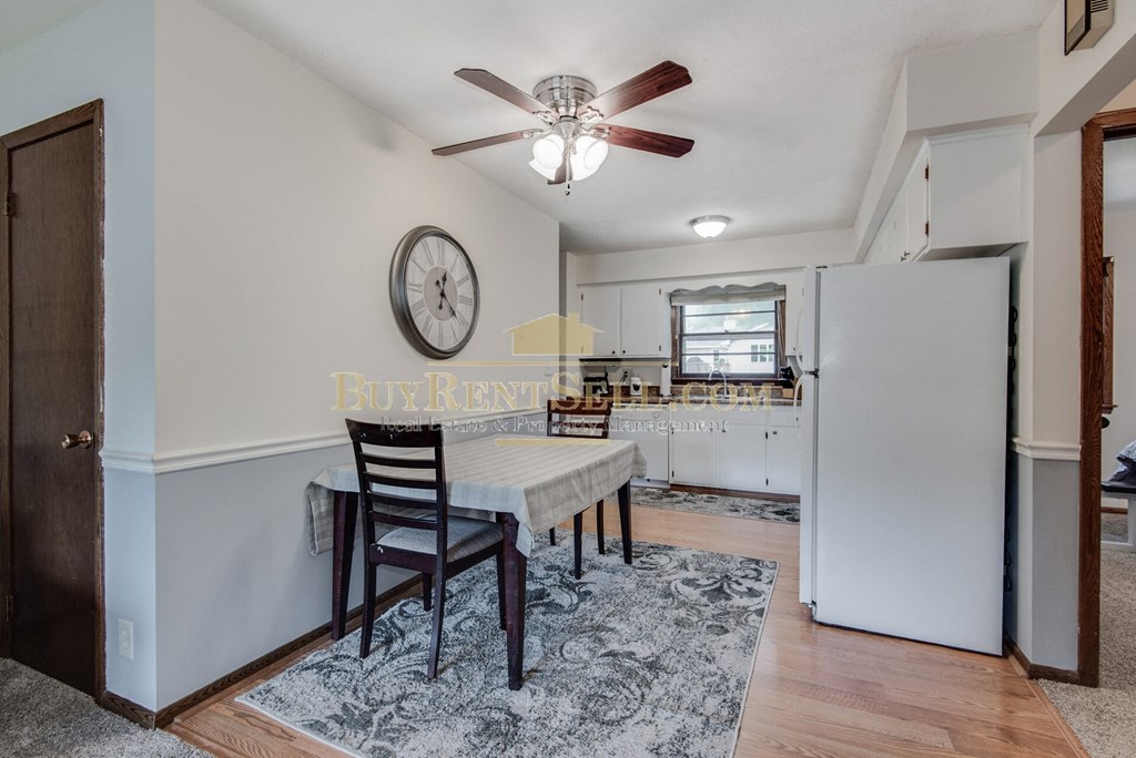 a kitchen with a dining table and a refrigerator