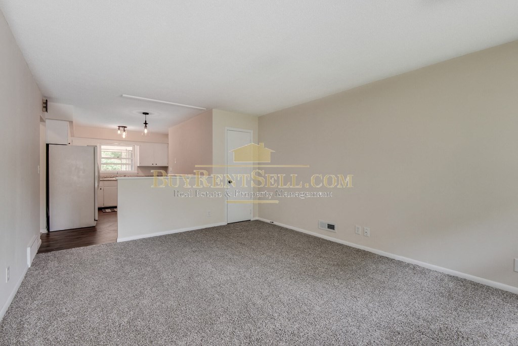 a bedroom apartment with a kitchen and a rug