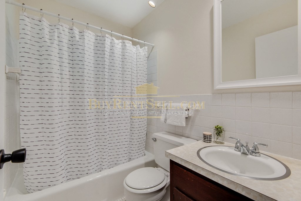 a bathroom with a sink and a toilet and a bath tub