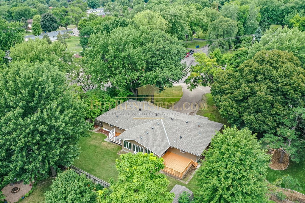 an aerial view of a house surrounded by trees
