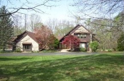 a large house in the middle of a field