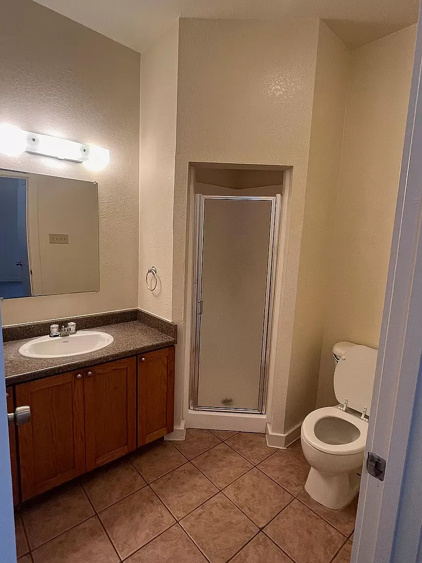 a bathroom with a sink toilet and a shower