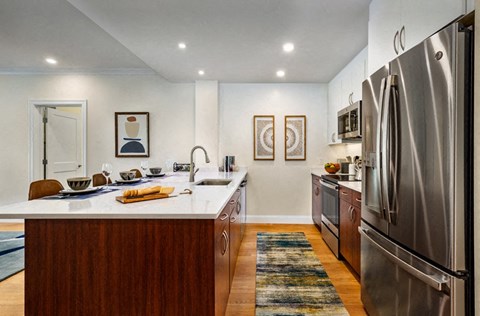 a kitchen with stainless steel appliances and a white counter top