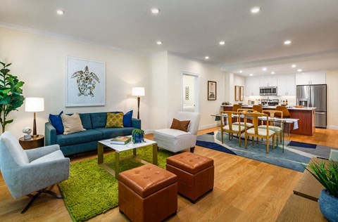 a living room with a couch and a table and a kitchen