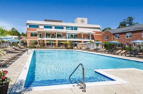 a swimming pool with a building in the background