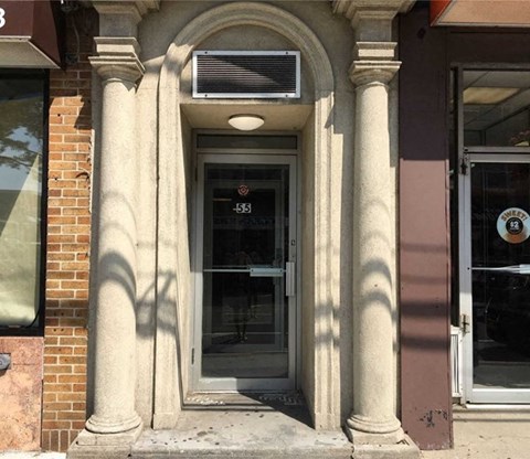 the front door of a building with columns