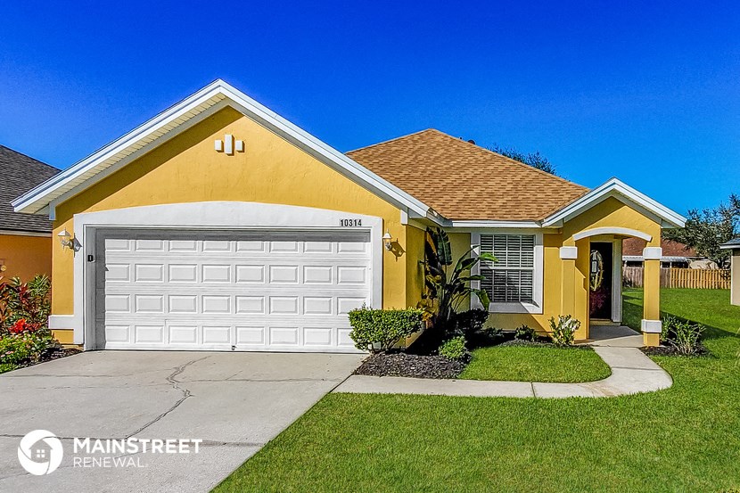 a yellow house with a white garage door