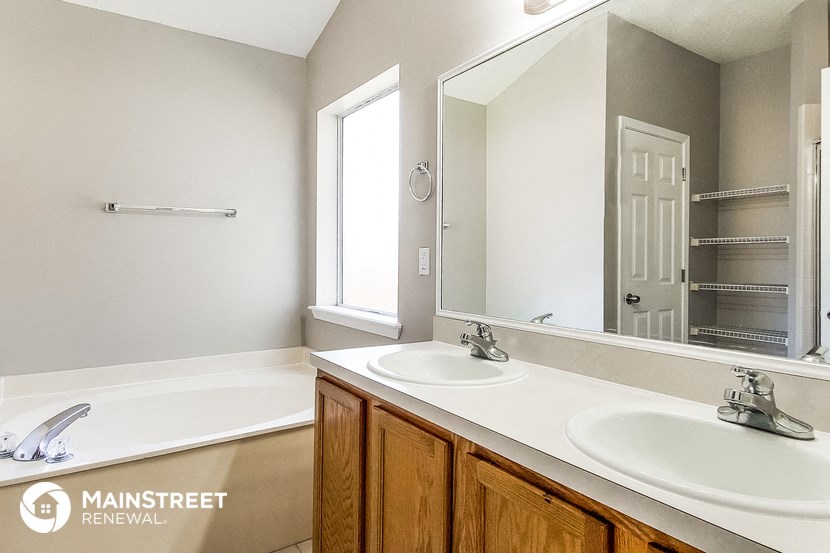 a bathroom with two sinks and a large mirror