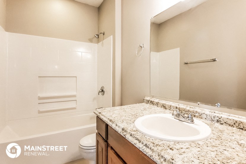 a bathroom with a sink and a toilet and a mirror