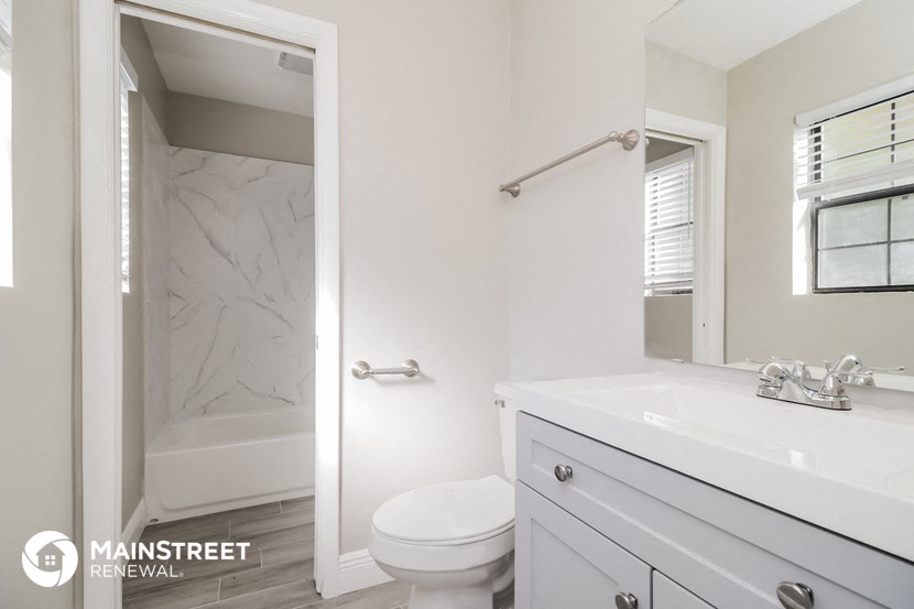 a bathroom with a sink and a toilet and a shower