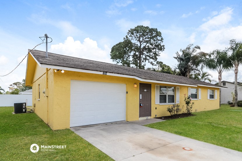a yellow house with a white garage door