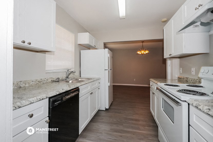 a kitchen with white appliances and granite counter tops