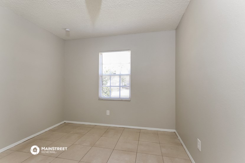 the living room of an empty house with a window
