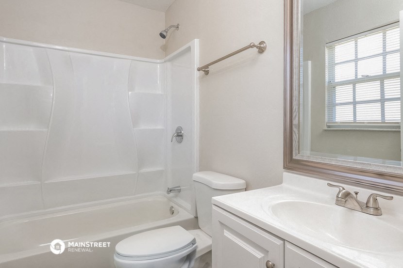 a white bathroom with a sink toilet and tub