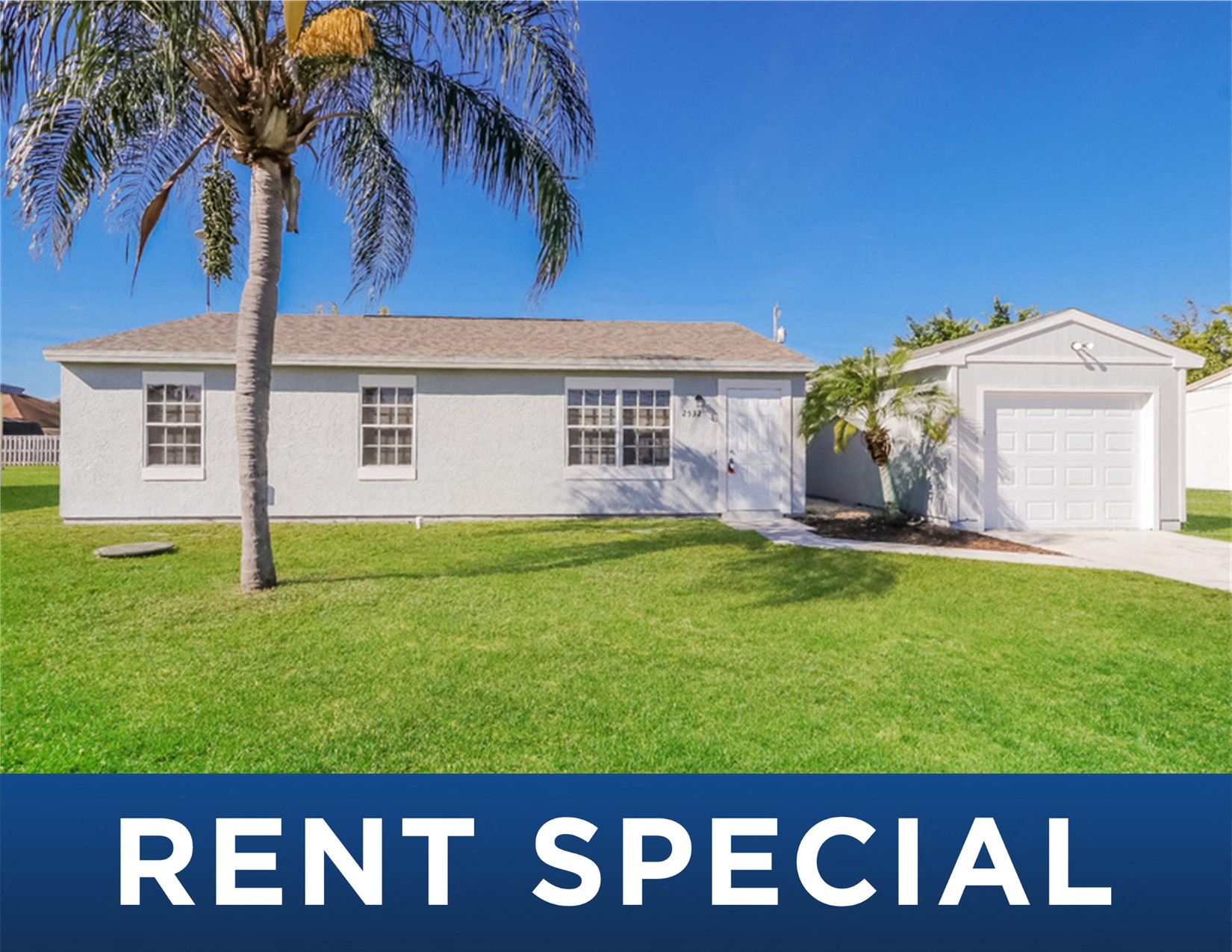 this is a picture of a rental house with a lawn and palm trees